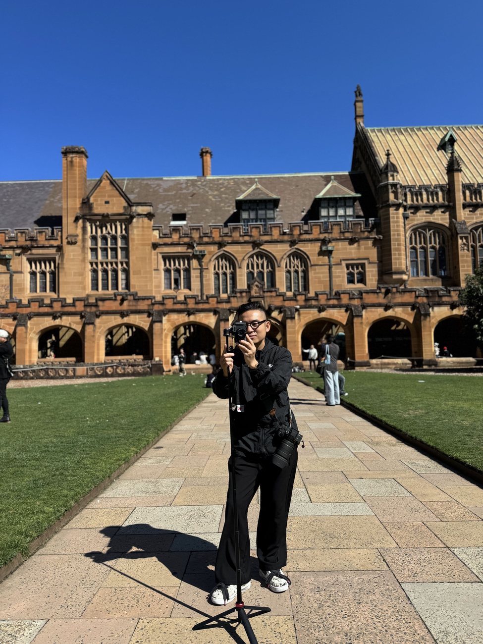 Cường shooting in a gothic sandstone courtyard