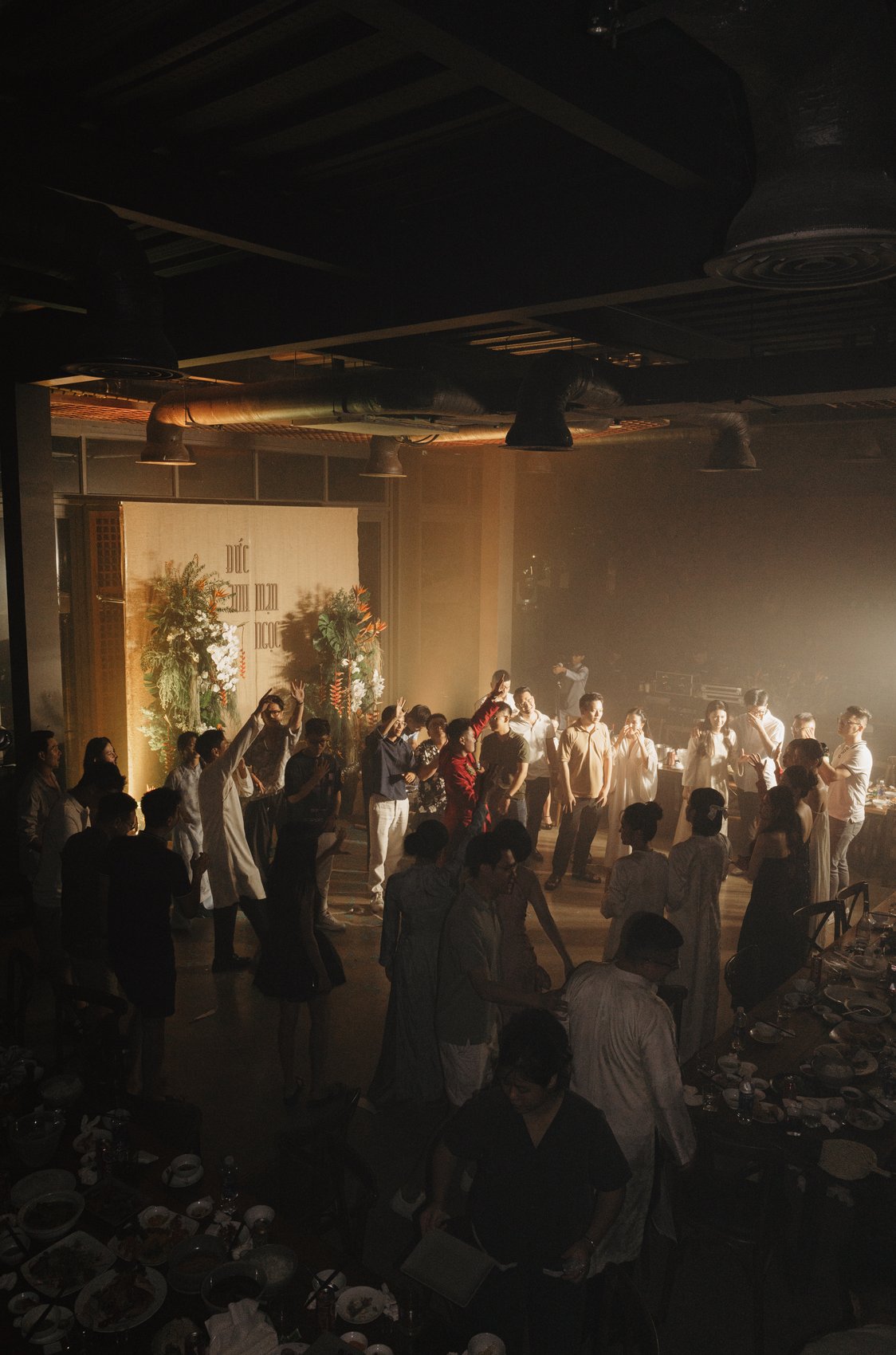Guests celebrating on the dance floor under the lights at a destination wedding reception, Vietnam