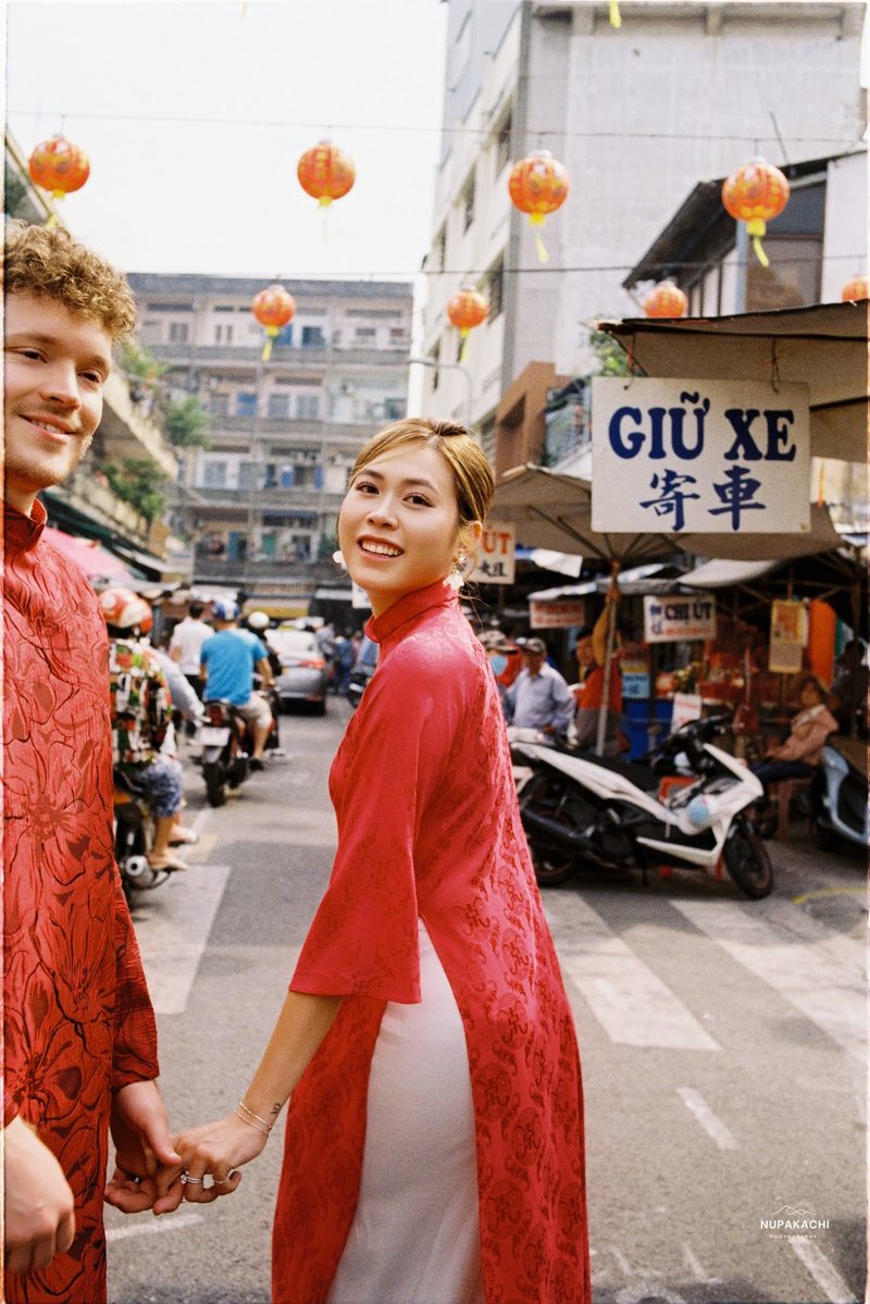 Bride and groom in red ao dai, Hong Kong vintage pre-wedding in Cholon on 35mm film (frame 1 of 12)