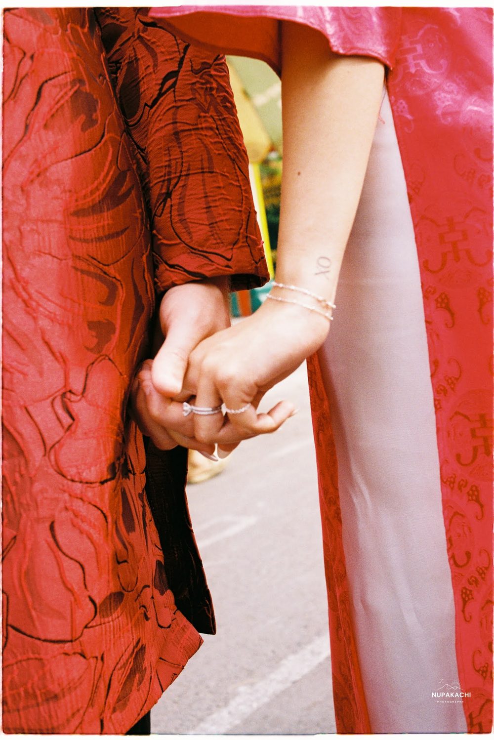 Hands held in red ao dai, 35mm film