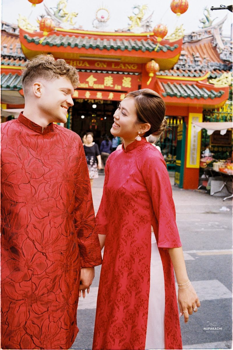 Bride and groom in red ao dai, Hong Kong vintage pre-wedding in Cholon on 35mm film (frame 3 of 12)