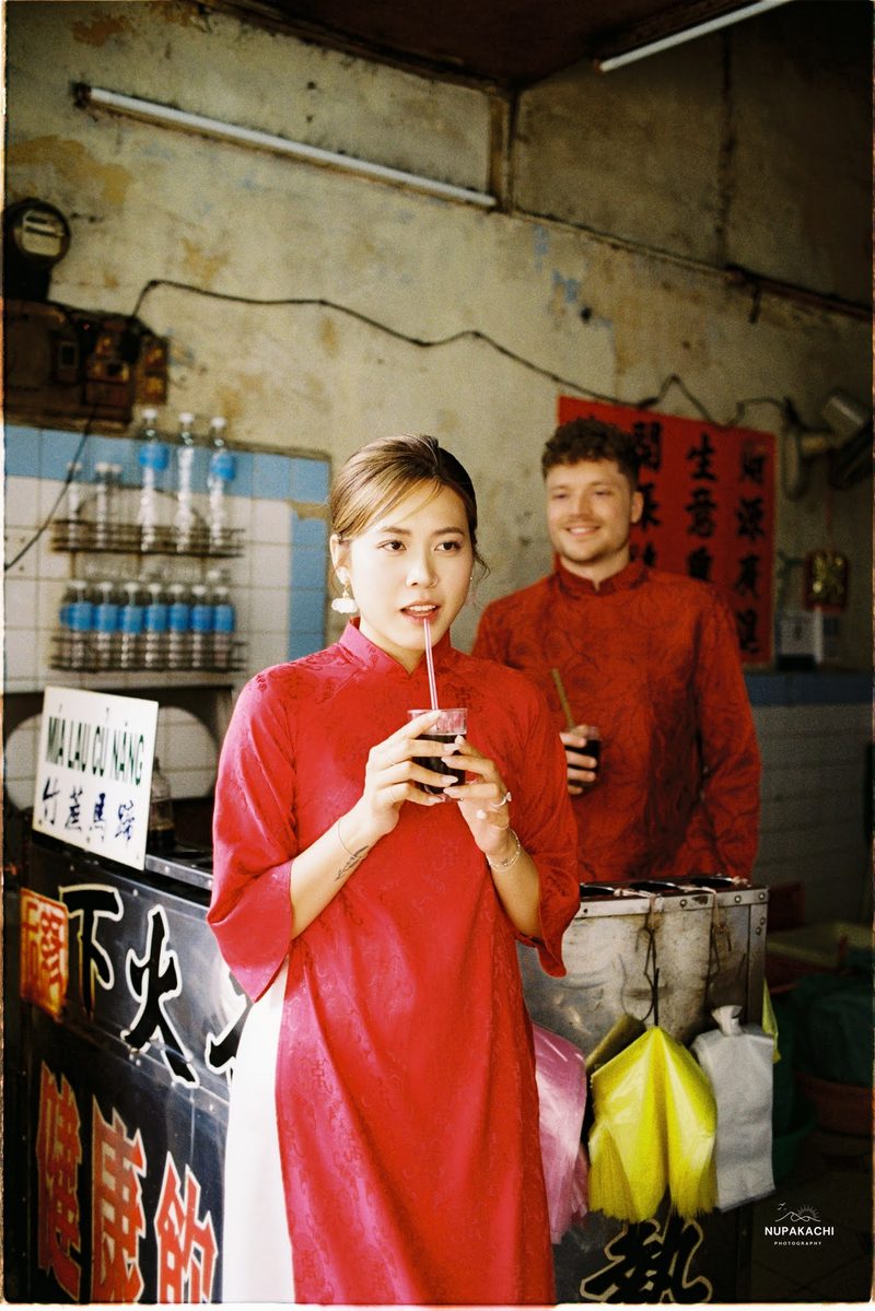 Bride and groom in red ao dai, Hong Kong vintage pre-wedding in Cholon on 35mm film (frame 9 of 12)