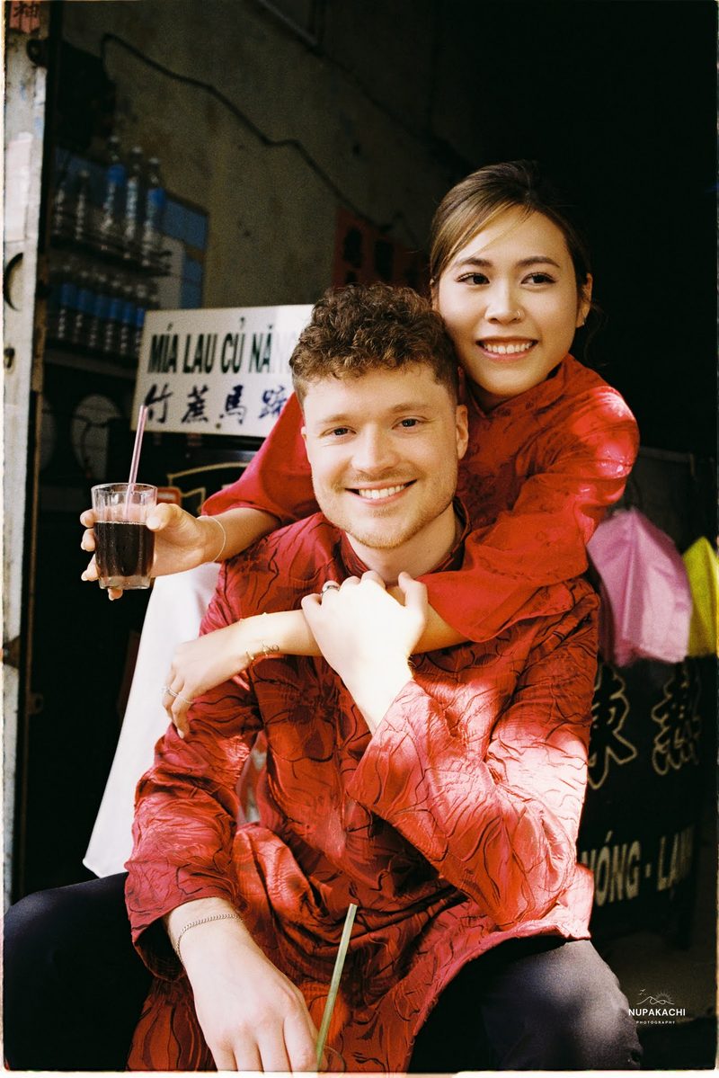 Bride and groom in red ao dai, Hong Kong vintage pre-wedding in Cholon on 35mm film (frame 12 of 12)