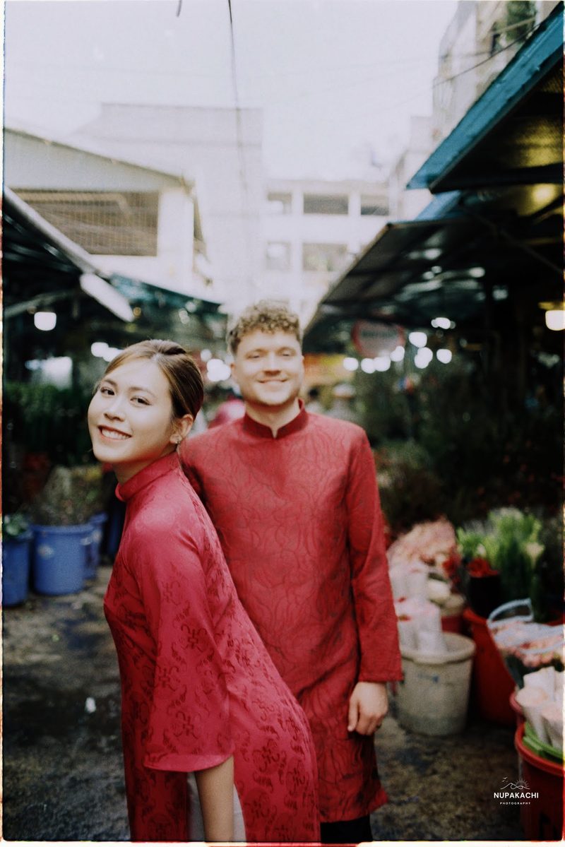 Bride and groom in red ao dai, Hong Kong vintage pre-wedding in Cholon on 35mm film (frame 11 of 12)