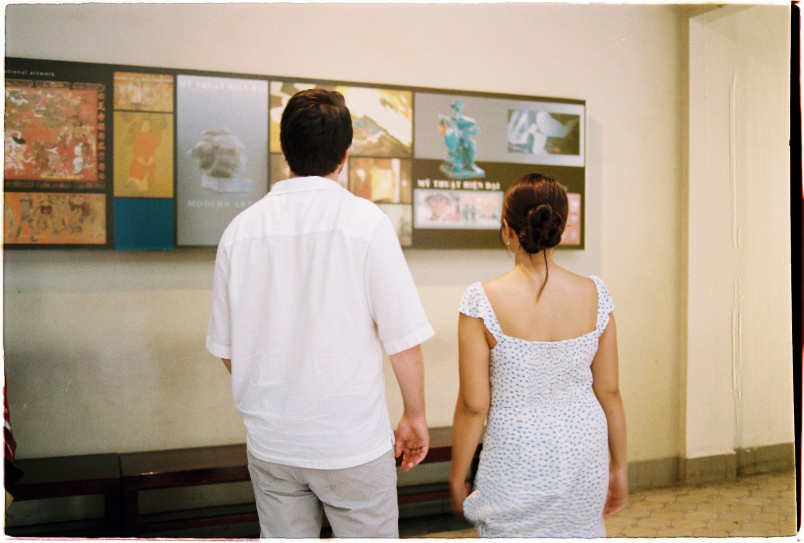 A couple looking at paintings in the Museum of Fine Arts, Saigon, on 35mm film