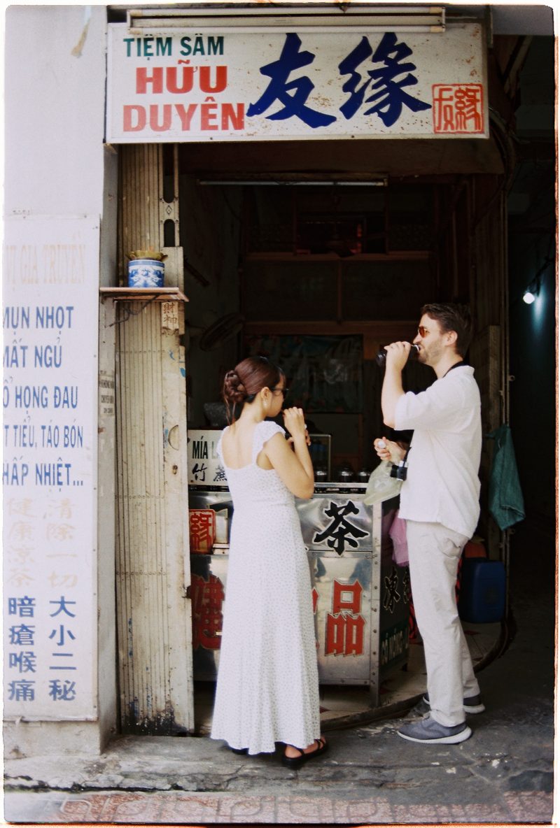 Couple in linen on the streets of District 5, Saigon, on 35mm film (frame 1 of 6)