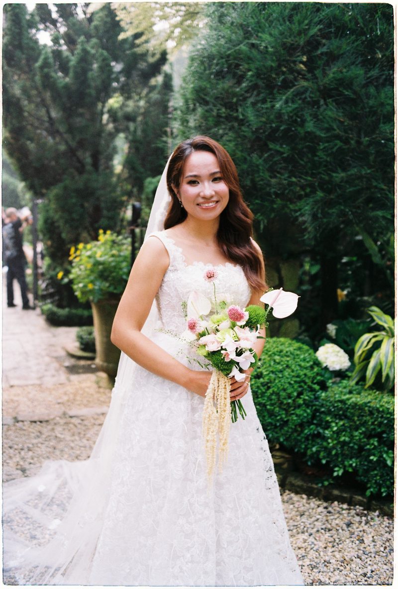 Bride and groom in a topiary garden and glasshouse on 35mm film (frame 1 of 12)