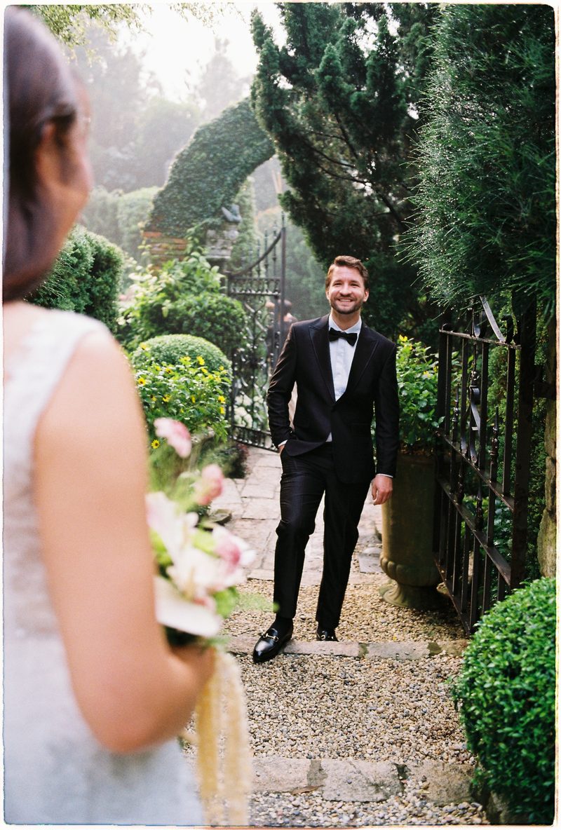 Bride and groom in a topiary garden and glasshouse on 35mm film (frame 2 of 12)