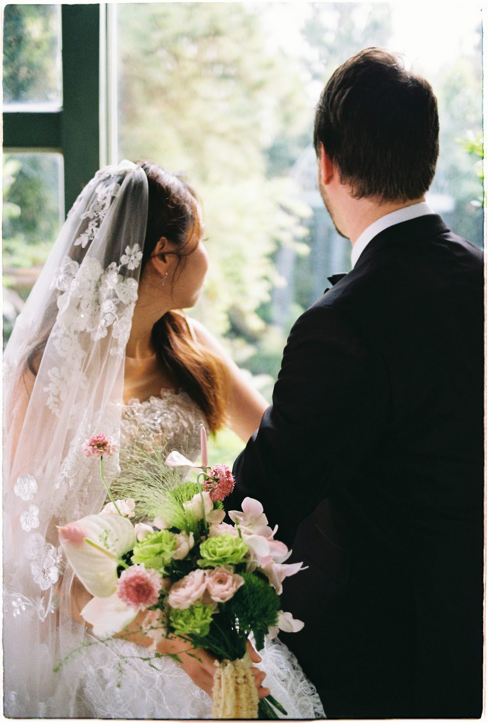 The bride looking up at the groom, 35mm film