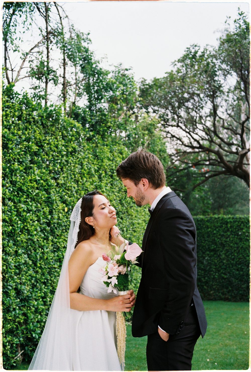 The bride laughing in a garden, 35mm film