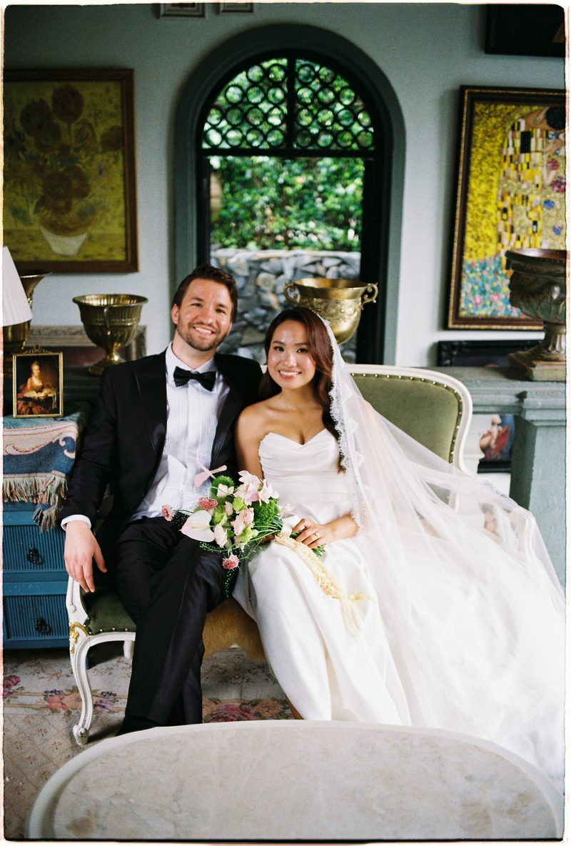 Bride and groom in a topiary garden and glasshouse on 35mm film (frame 10 of 12)