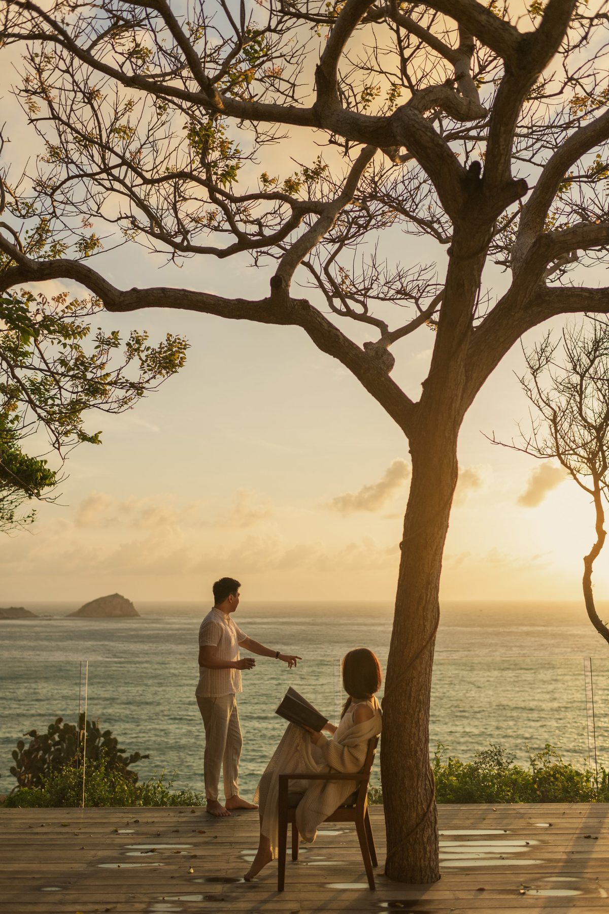 Golden hour pre-wedding photography under a seaside tree in Vietnam by Nupakachi