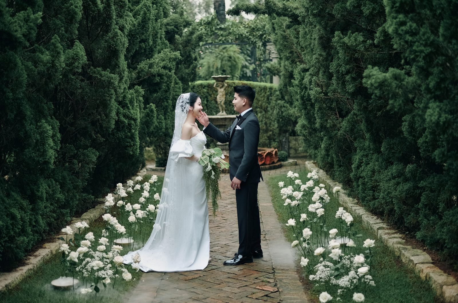 Long & Linh on the cypress path at Vu Garden