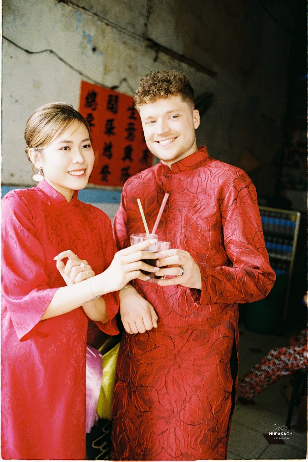 Red ao dai for both at a herbal tea stall in Cholon, on 35mm film