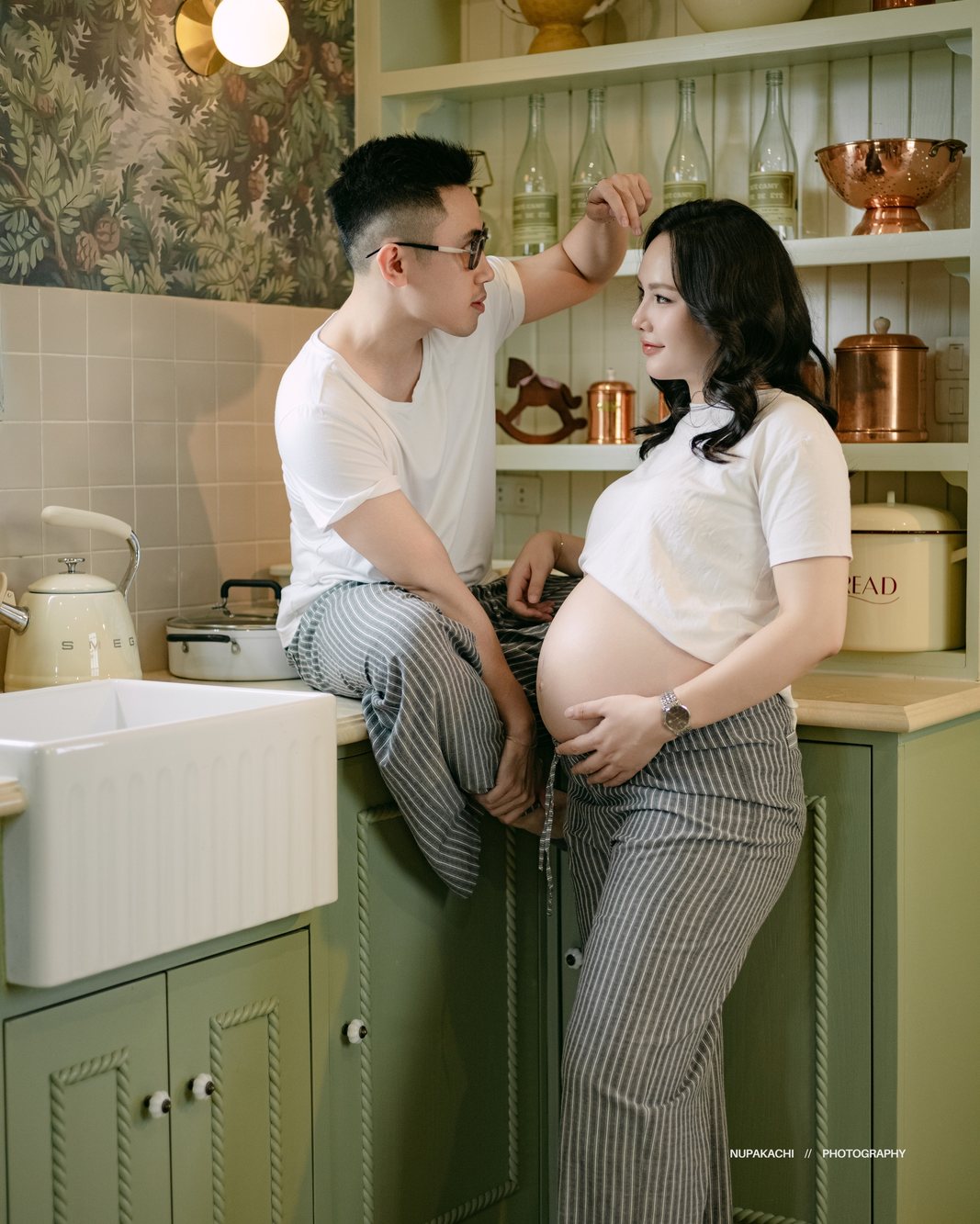 Expecting couple together in a green kitchen, maternity photography Hanoi