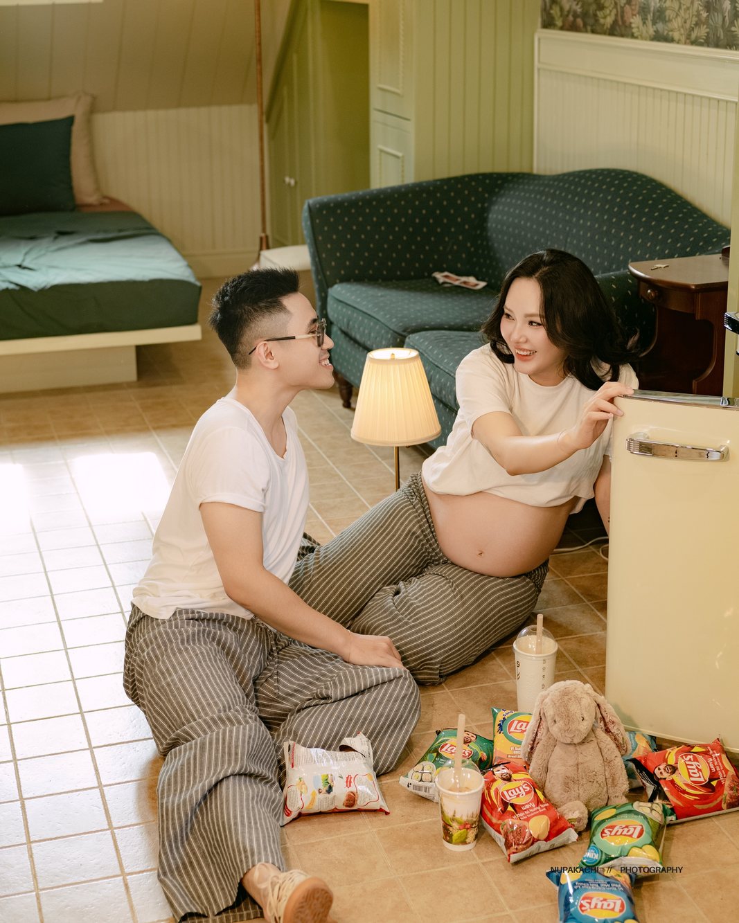 Expecting couple sitting on the floor with baby toys, lifestyle maternity photography