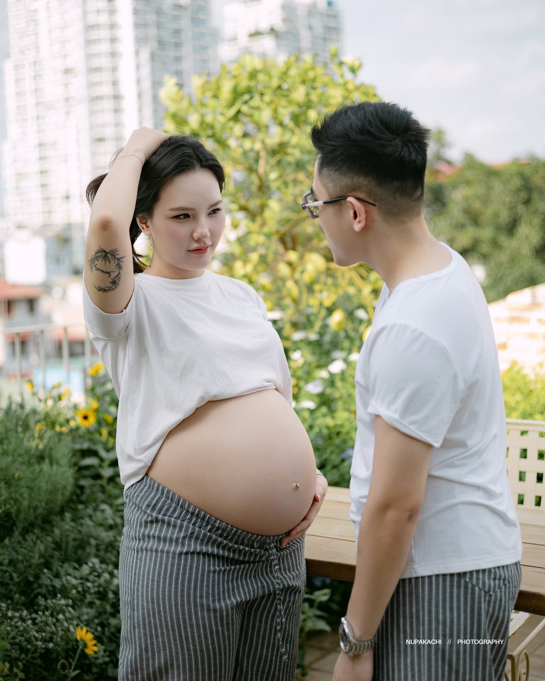 Expecting couple on a rooftop garden in the city, outdoor maternity photography Hanoi