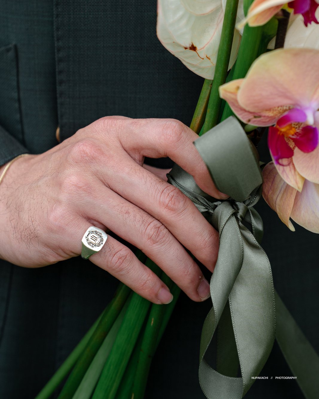 Close up of the wedding ring and the orchid bouquet, wedding detail photography