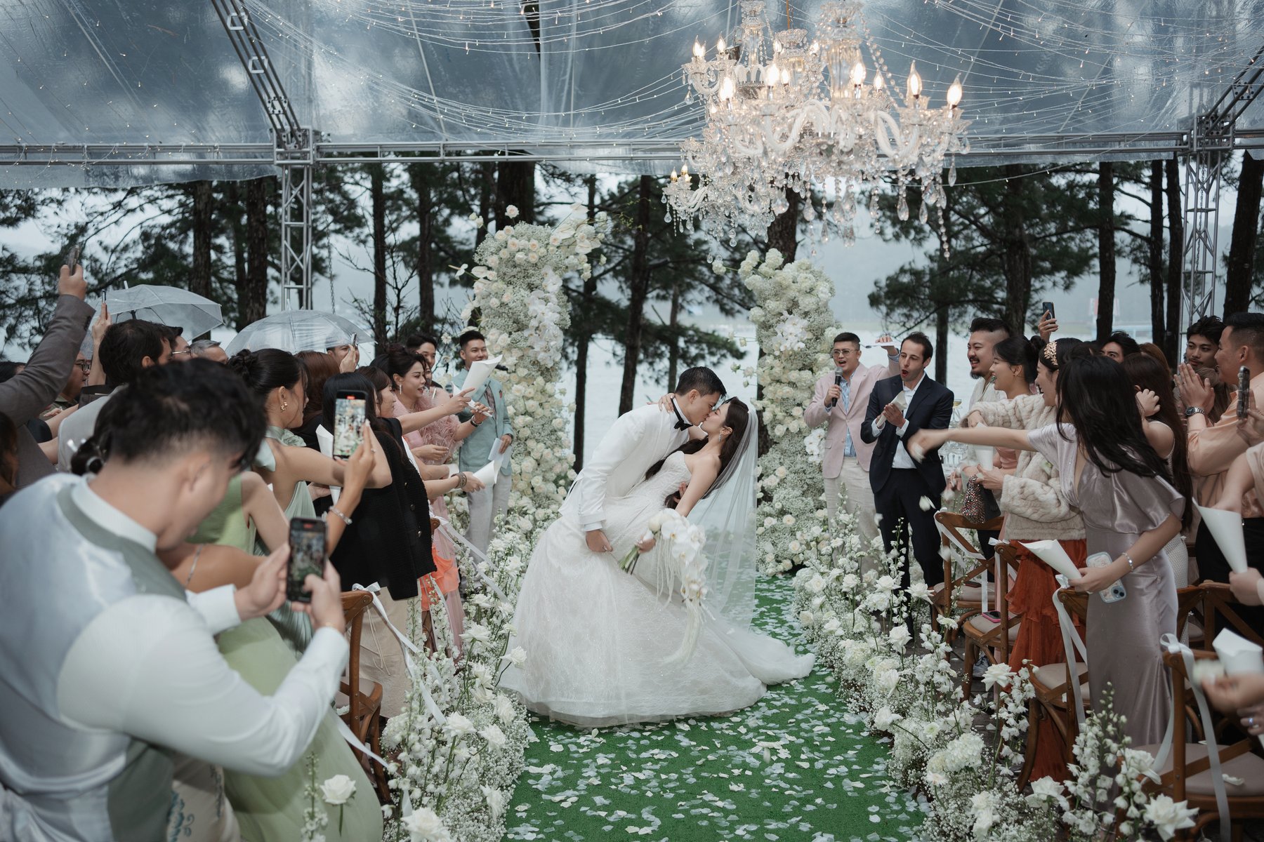 First dance surrounded by guests at a forest wedding reception in Vietnam