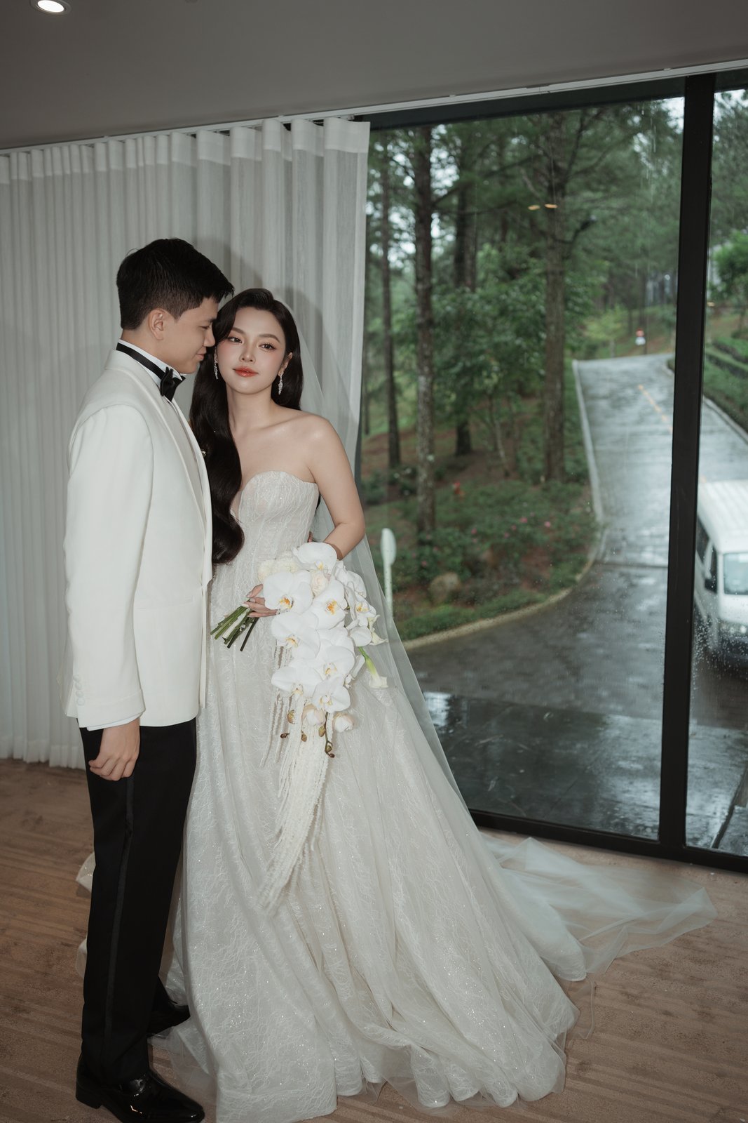 Bride and groom in white tuxedo after the ceremony, elegant Vietnam wedding