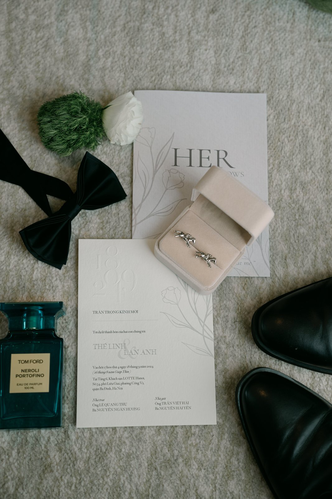 Flat lay of wedding invitation, rings and groom accessories, Vietnam wedding details