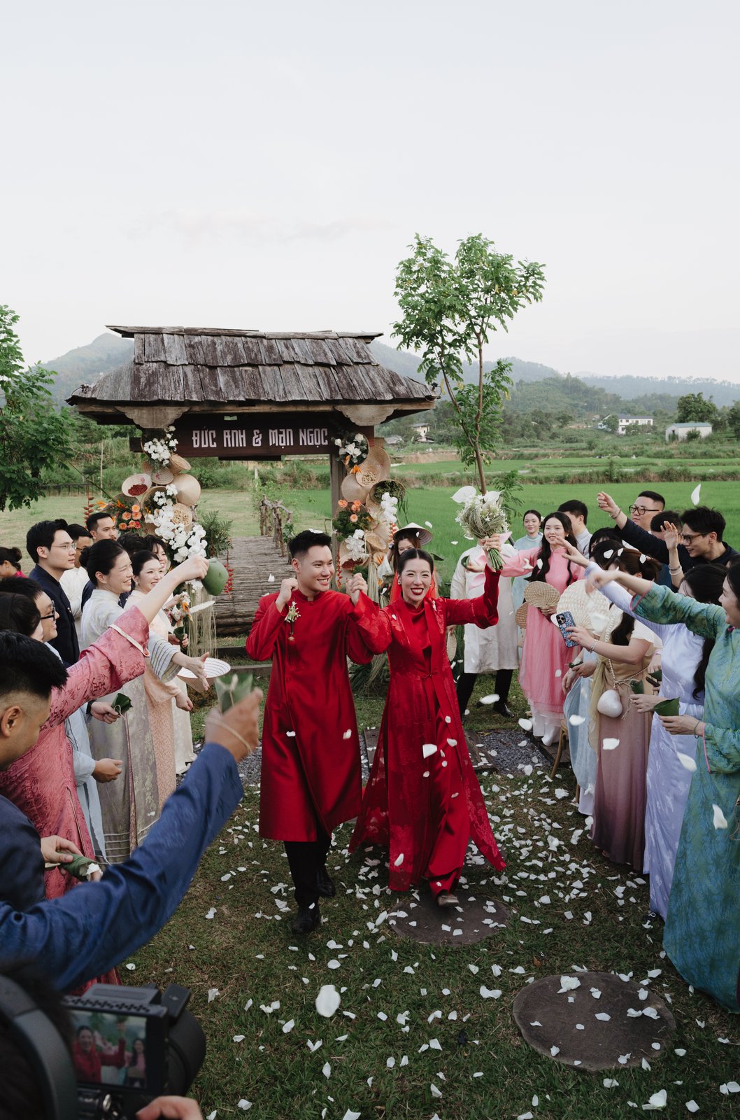 Wedding procession in red ao dai with flower petals, Vietnamese tradition