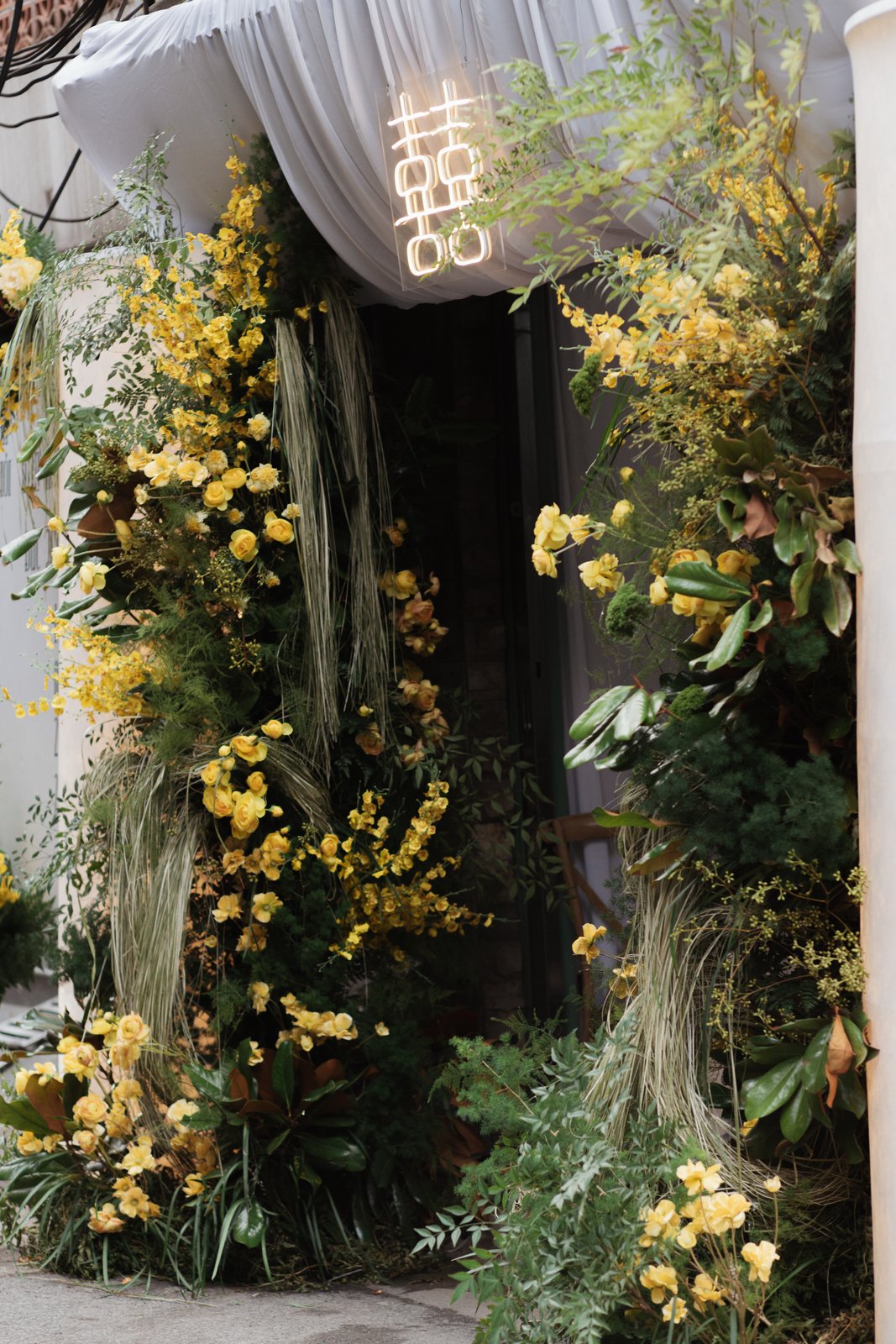 Traditional Vietnamese wedding gate with yellow flowers and double happiness sign, Hanoi