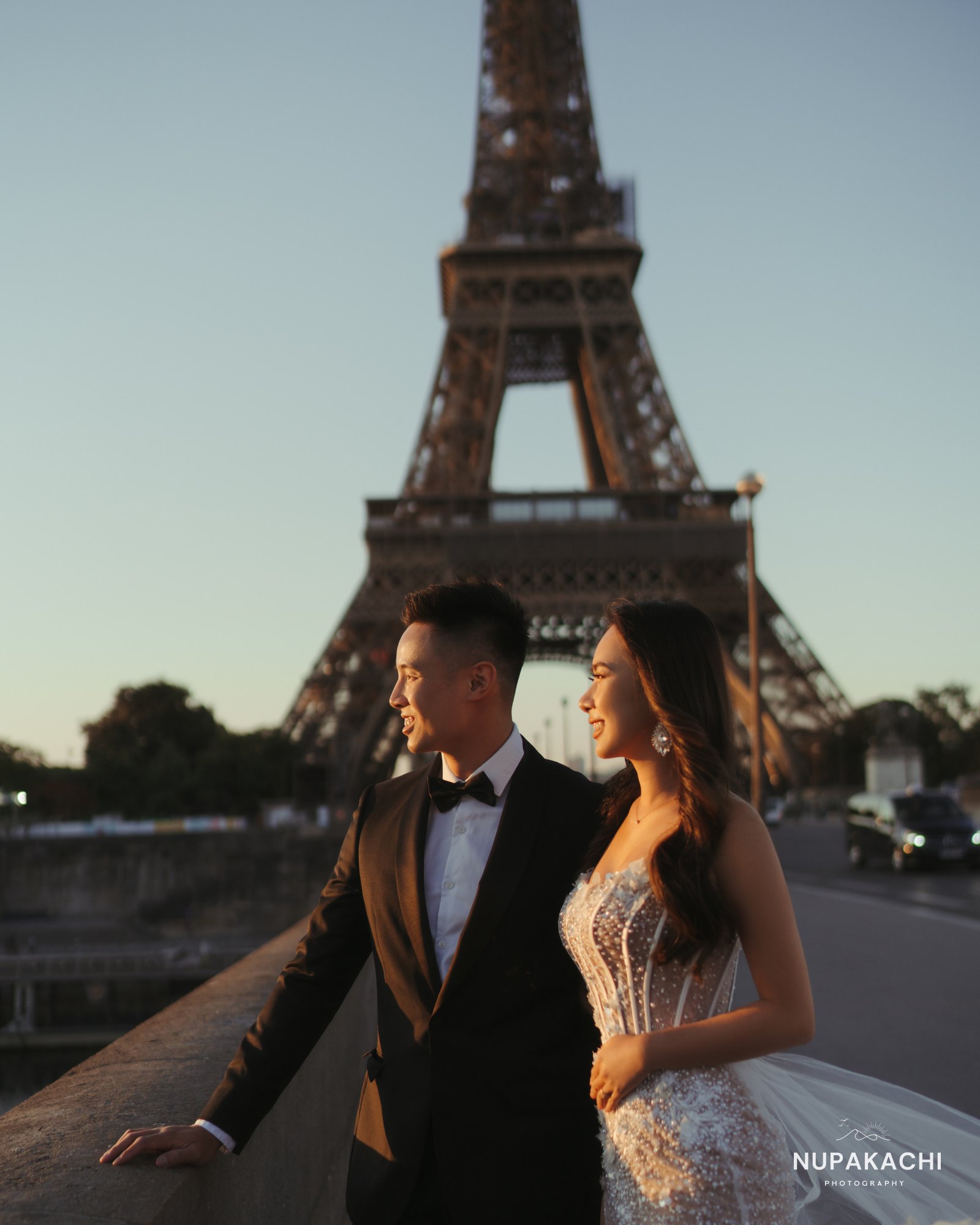 Bride in evening gown with groom at the Eiffel Tower, Paris pre-wedding by Nupakachi