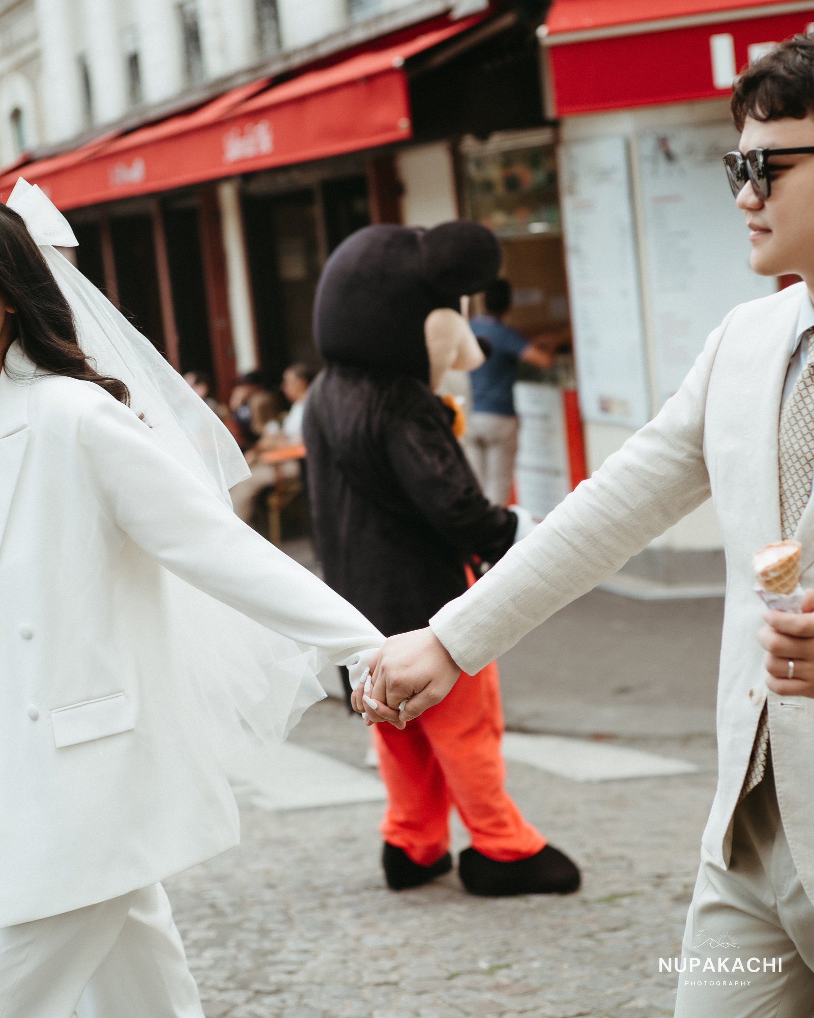 Ice cream and laughter on a Paris street, playful pre-wedding