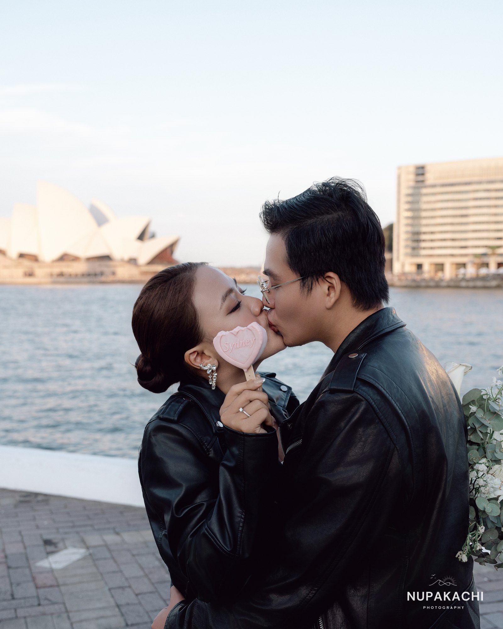 Playful kiss by Sydney Opera House, Australia pre-wedding by Nupakachi