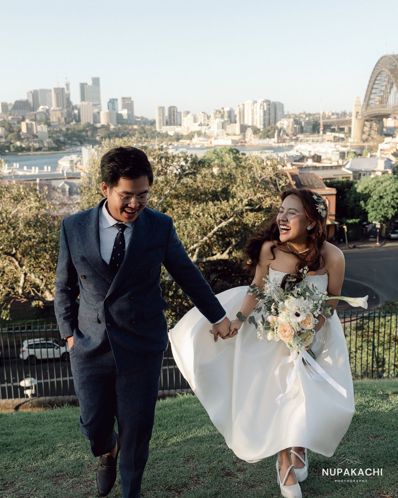 Couple with the Sydney skyline and Harbour Bridge behind, Australia