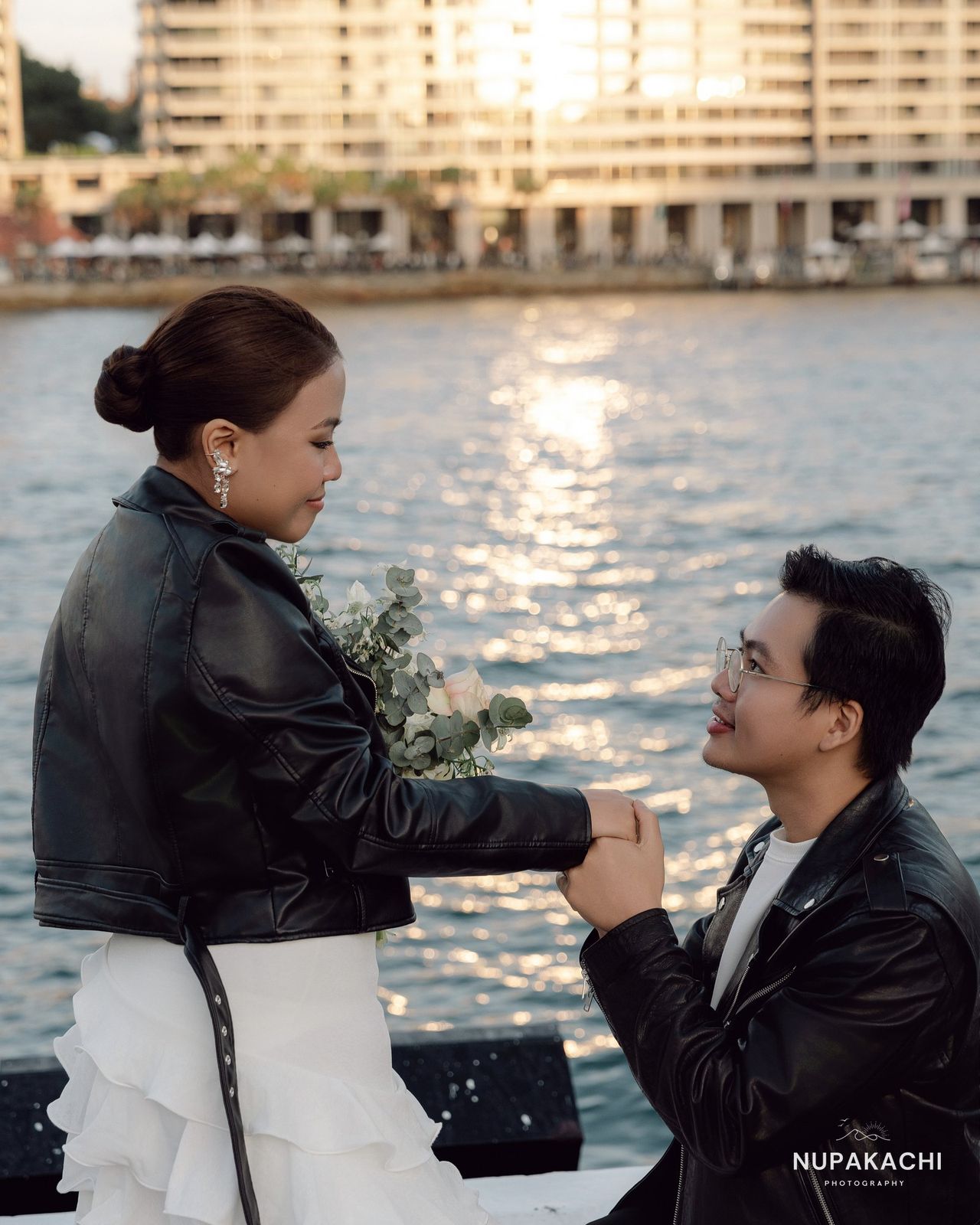 Leather jackets over wedding attire by Sydney Harbour at sunset
