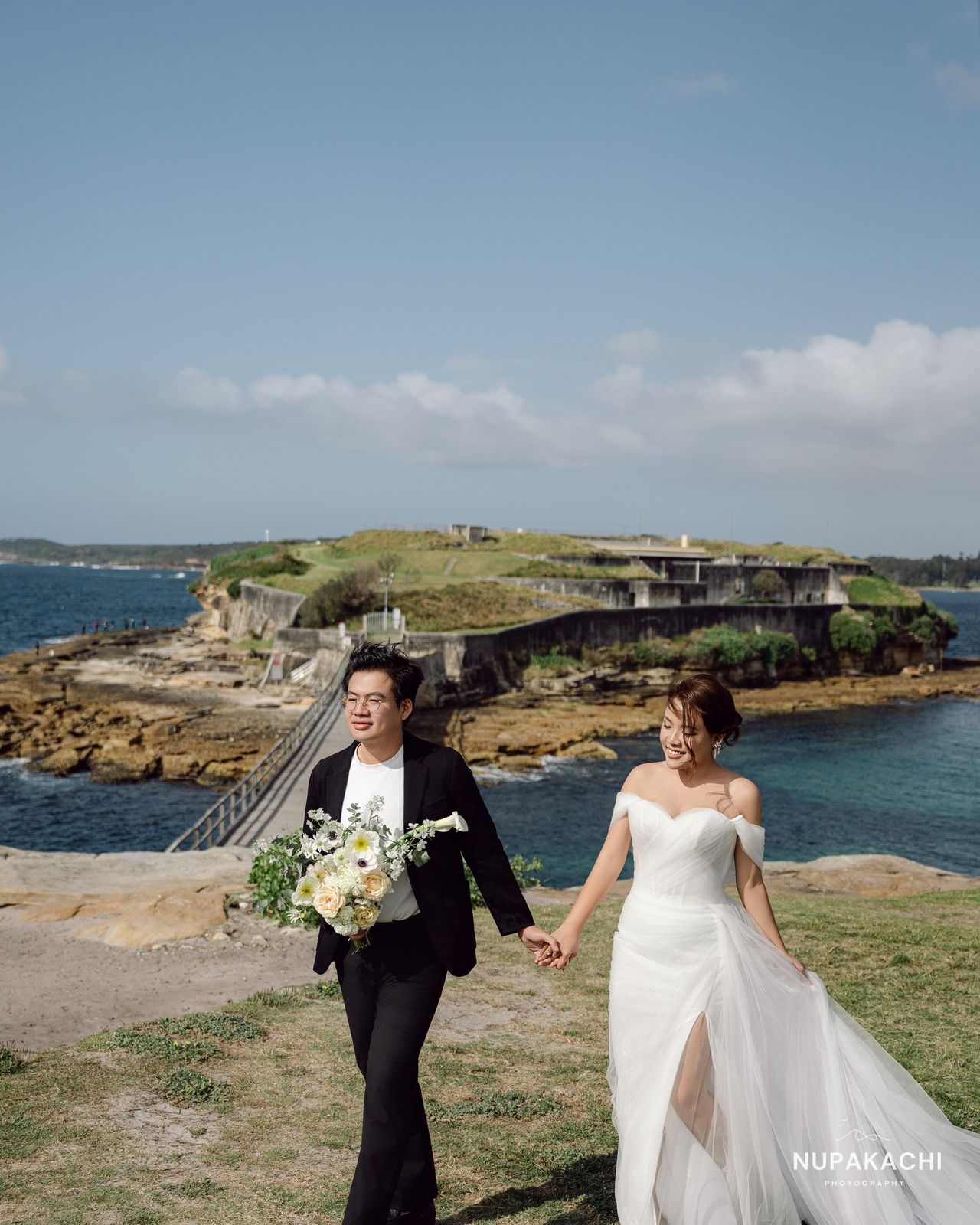 Bride and groom on a coastal headland, Sydney Australia